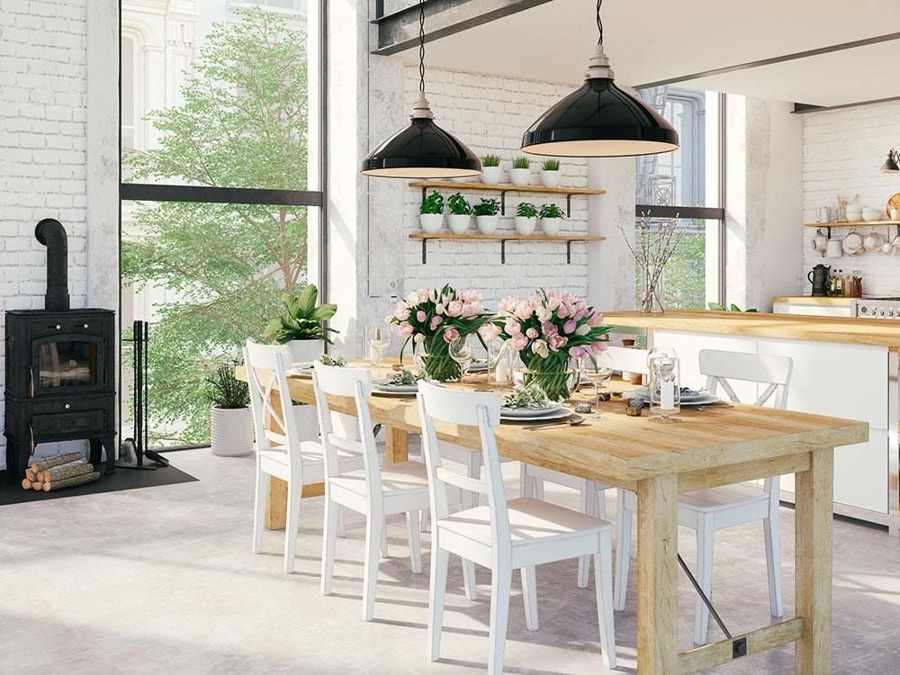 Bright farmhouse kitchen and dining space with white brick and wood table